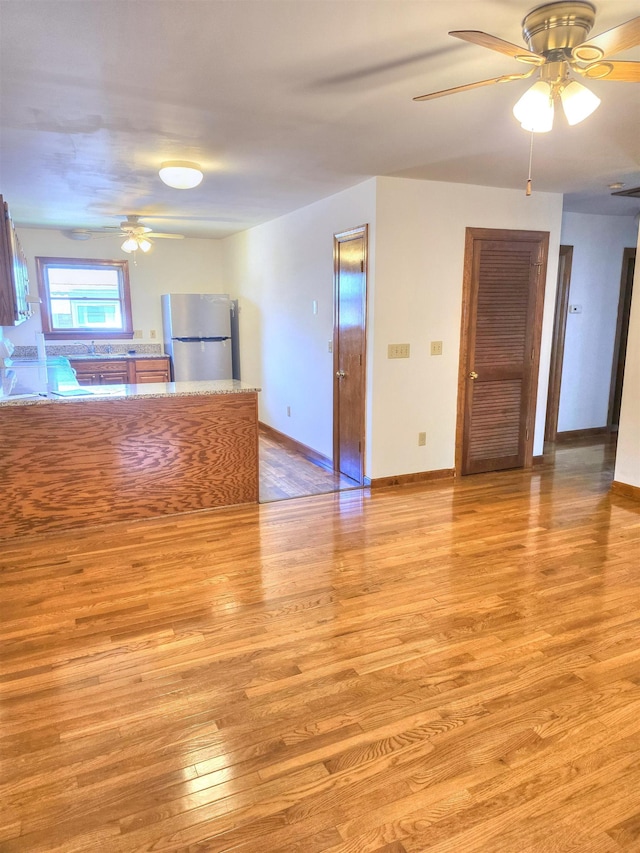 405 Linden Ave S Unit 1, Waynesboro, VA 22980 - unfurnished living room with ceiling fan, light wood-type flooring, and baseboards