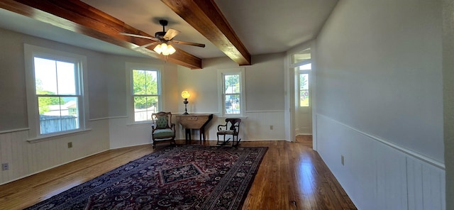 242 1st St, Broadway, VA 22815 - sitting room with beamed ceiling, ceiling fan, wood finished floors, and a wainscoted wall
