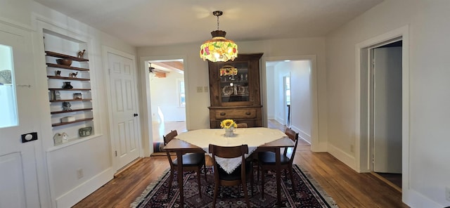 242 1st St, Broadway, VA 22815 - dining space featuring dark wood-style flooring, built in features, and a chandelier
