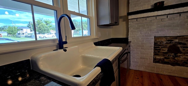 242 1st St, Broadway, VA 22815 - kitchen view of dark wood-style flooring, a fireplace, and dishwasher