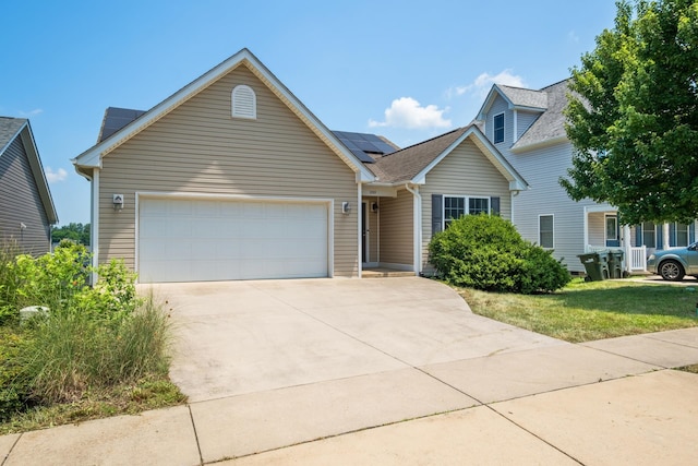 233 Overview St, Waynesboro, VA 22980 - traditional-style home featuring an attached garage, roof mounted solar panels, driveway, a shingled roof, and a front lawn