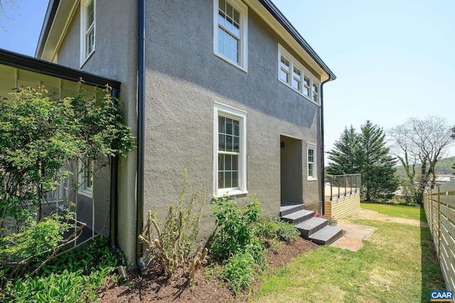 back of house featuring stucco siding