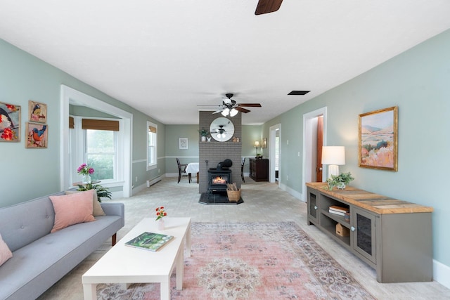 199 Hermitage Rd, Staunton, VA 24401 - living area with ceiling fan, a wood stove, baseboards, and a baseboard heating unit