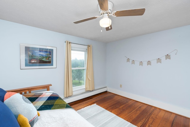 199 Hermitage Rd, Staunton, VA 24401 - bedroom featuring a baseboard radiator, wood finished floors, baseboards, and ceiling fan