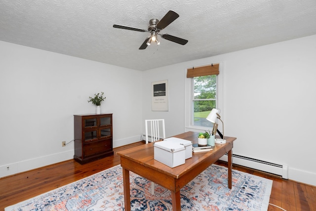 199 Hermitage Rd, Staunton, VA 24401 - office area featuring baseboard heating, wood finished floors, a ceiling fan, baseboards, and a textured ceiling