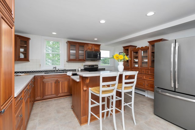199 Hermitage Rd, Staunton, VA 24401 - kitchen featuring freestanding refrigerator, a sink, a kitchen bar, electric stove, and tasteful backsplash