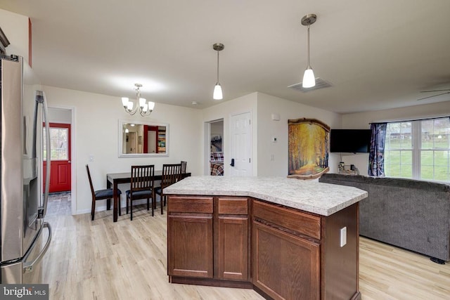 147 Fishermans Ln, Luray, VA 22835 - kitchen featuring stainless steel fridge, light wood-style floors, light countertops, a chandelier, and plenty of natural light