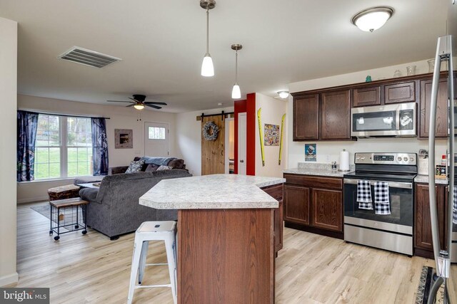 147 Fishermans Ln, Luray, VA 22835 - kitchen featuring appliances with stainless steel finishes, light wood-style flooring, light countertops, open floor plan, and a kitchen island