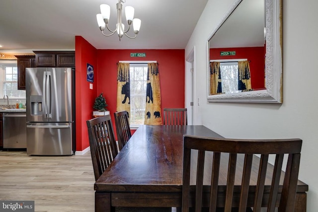 147 Fishermans Ln, Luray, VA 22835 - dining room featuring a chandelier, light wood-type flooring, and plenty of natural light