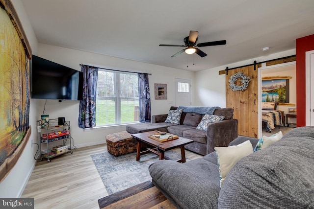 147 Fishermans Ln, Luray, VA 22835 - living room featuring baseboards, a ceiling fan, a barn door, and healthy amount of natural light
