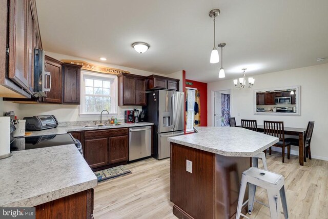 147 Fishermans Ln, Luray, VA 22835 - kitchen featuring stainless steel appliances, a sink, light wood-style flooring, and light countertops