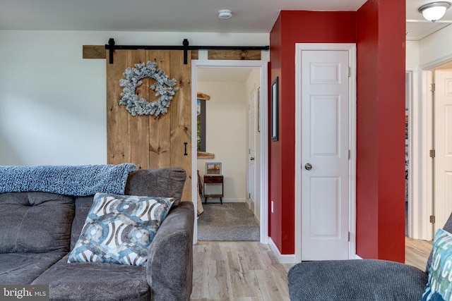 147 Fishermans Ln, Luray, VA 22835 - living room with light wood-style flooring, a barn door, and baseboards