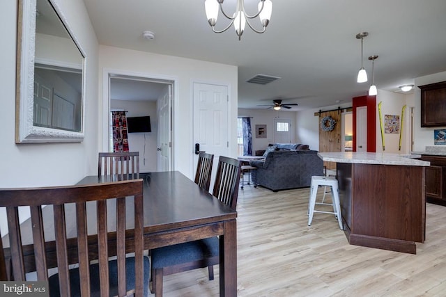 147 Fishermans Ln, Luray, VA 22835 - dining area featuring light wood-type flooring, a barn door, a chandelier, and a ceiling fan