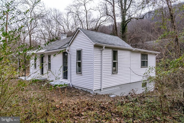1121 Monacan Trail Rd, Charlottesville, VA 22903 - view of home's exterior featuring roof with shingles and a chimney
