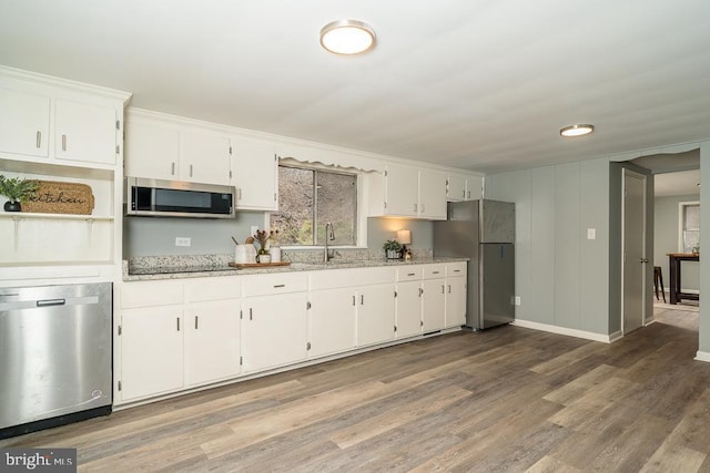 1121 Monacan Trail Rd, Charlottesville, VA 22903 - kitchen featuring stainless steel appliances, white cabinets, light wood-style flooring, and light stone countertops