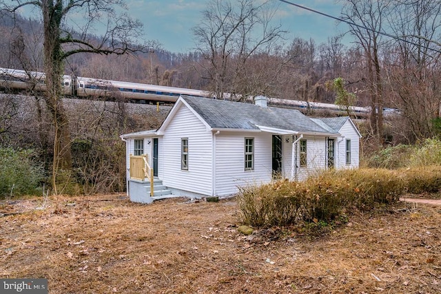 1121 Monacan Trail Rd, Charlottesville, VA 22903 - view of side of home with a shingled roof and a chimney