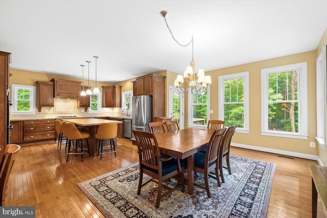 9937 Talley Rd, Spotsylvania, VA 22553 - dining room with a chandelier and light wood-type flooring