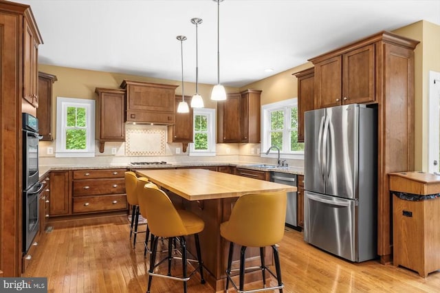 9937 Talley Rd, Spotsylvania, VA 22553 - kitchen with stainless steel appliances, butcher block countertops, light wood-style floors, brown cabinets, and recessed lighting