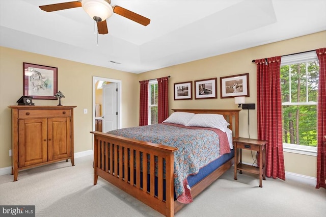 9937 Talley Rd, Spotsylvania, VA 22553 - bedroom featuring light carpet, a tray ceiling, ensuite bathroom, and a ceiling fan