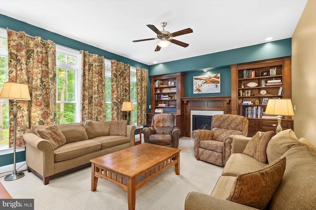 9937 Talley Rd, Spotsylvania, VA 22553 - living room featuring a glass covered fireplace, a ceiling fan, and light colored carpet