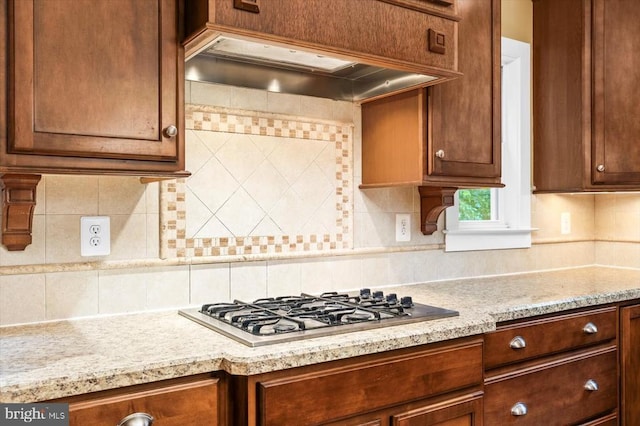 9937 Talley Rd, Spotsylvania, VA 22553 - kitchen with custom exhaust hood, stainless steel gas cooktop, tasteful backsplash, and light stone countertops