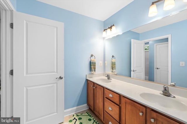 9937 Talley Rd, Spotsylvania, VA 22553 - bathroom with double vanity and baseboards