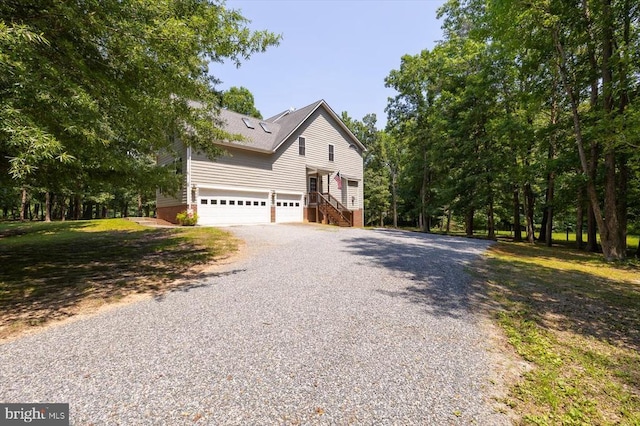 9937 Talley Rd, Spotsylvania, VA 22553 - view of property exterior featuring a garage, driveway, and stairs