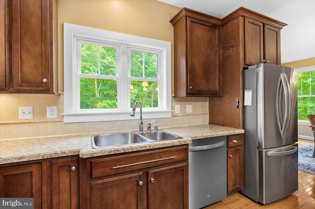 9937 Talley Rd, Spotsylvania, VA 22553 - kitchen featuring stainless steel appliances, light wood-style flooring, tasteful backsplash, and light countertops