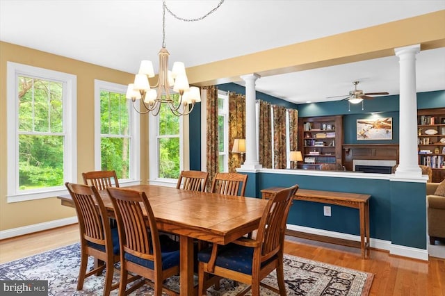 9937 Talley Rd, Spotsylvania, VA 22553 - dining area featuring ornate columns, a ceiling fan, wood finished floors, and a fireplace