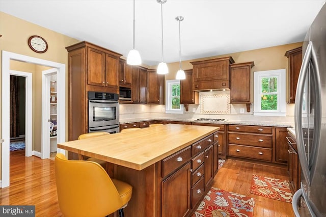9937 Talley Rd, Spotsylvania, VA 22553 - kitchen with butcher block countertops, appliances with stainless steel finishes, wood finished floors, and plenty of natural light