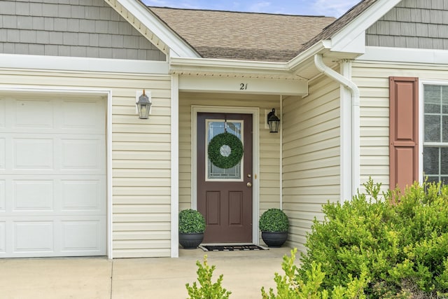 21 Upland Ct, Stuarts Draft, VA 24477 - view of exterior entry featuring roof with shingles, an attached garage, and driveway