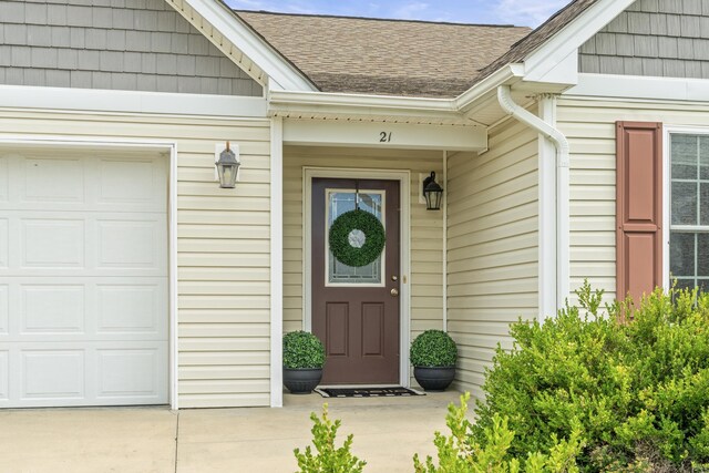 21 Upland Ct, Stuarts Draft, VA 24477 - view of exterior entry featuring roof with shingles, an attached garage, and driveway