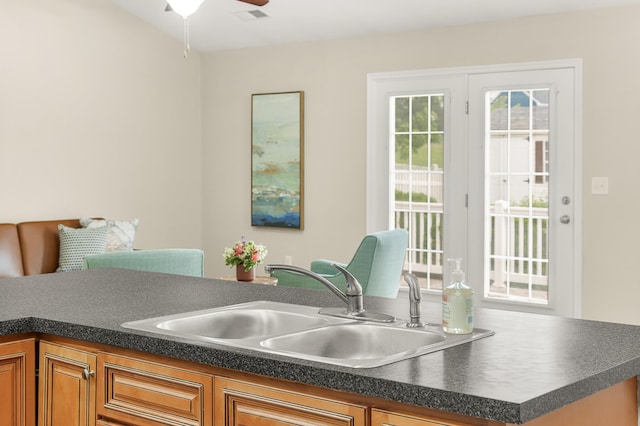 21 Upland Ct, Stuarts Draft, VA 24477 - kitchen featuring dark countertops, ceiling fan, and brown cabinets