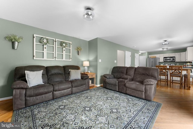  - living room with light wood-type flooring