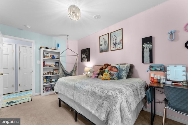  - bedroom featuring carpet flooring and a chandelier