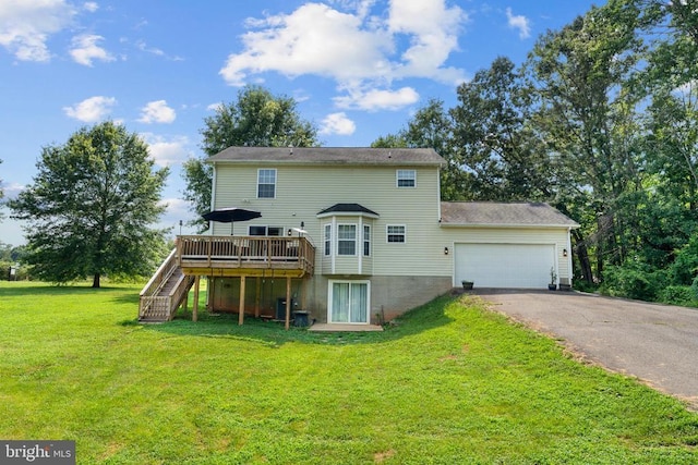  - back of house with driveway, a wooden deck, a garage, stairway, and a lawn