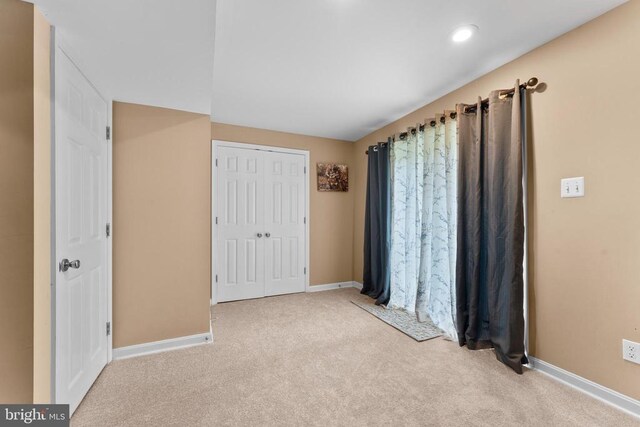  - unfurnished bedroom with carpet flooring, a closet, and recessed lighting