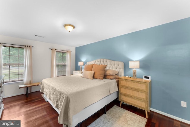  - bedroom with wood finished floors and baseboards