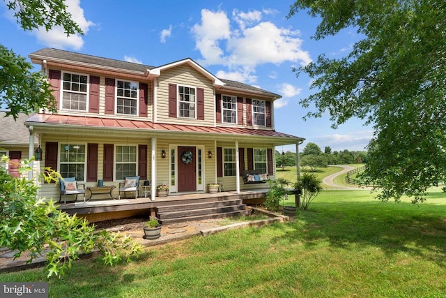  - colonial-style house featuring a porch and a front yard