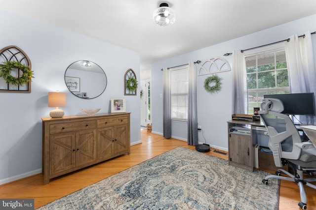  - office area featuring healthy amount of natural light and light wood-style floors