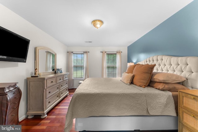  - bedroom with dark wood finished floors