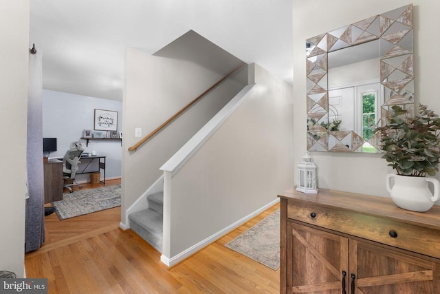  - stairway with wood finished floors and baseboards