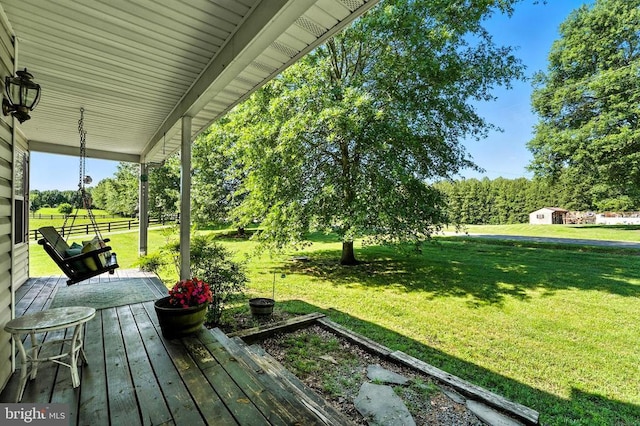  - wooden porch with a lawn and a shed