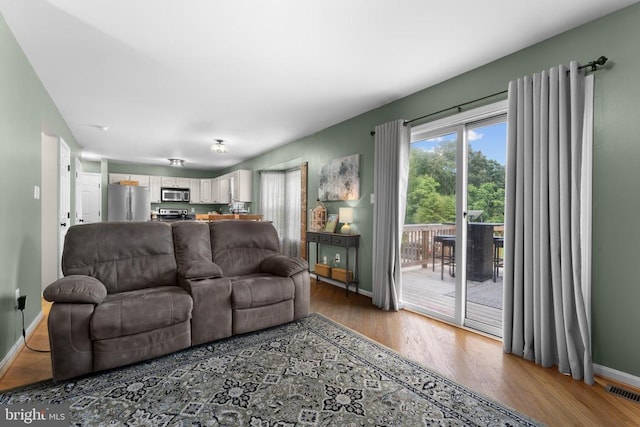  - living area with wood finished floors and baseboards