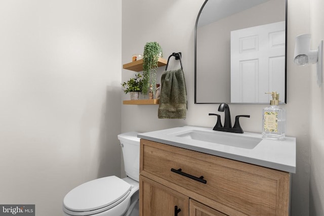  - half bathroom featuring vanity and toilet
