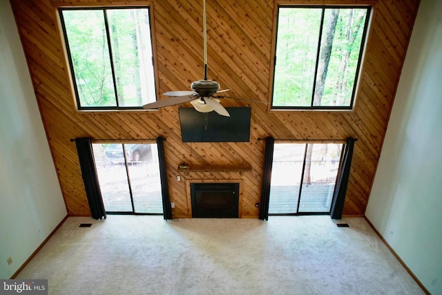 107 Birchside Cir, Locust Grove, VA 22508 - unfurnished living room featuring ceiling fan, wooden walls, a fireplace, carpet, and baseboards