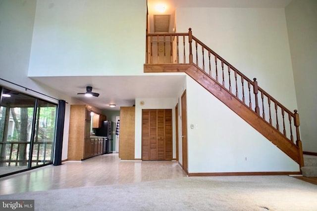 107 Birchside Cir, Locust Grove, VA 22508 - unfurnished living room with carpet flooring, a high ceiling, baseboards, stairs, and a ceiling fan