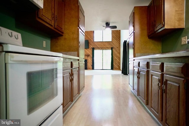 107 Birchside Cir, Locust Grove, VA 22508 - kitchen featuring stove, wood walls, light wood-style floors, and a ceiling fan