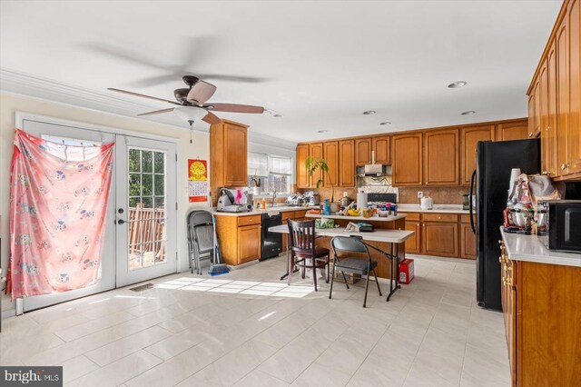 1745 Finley Dr, Culpeper, VA 22701 - kitchen with brown cabinetry, light countertops, under cabinet range hood, black appliances, and ceiling fan
