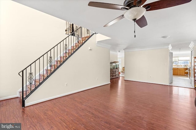 1745 Finley Dr, Culpeper, VA 22701 - unfurnished living room with wood finished floors, ornamental molding, ceiling fan, and stairway